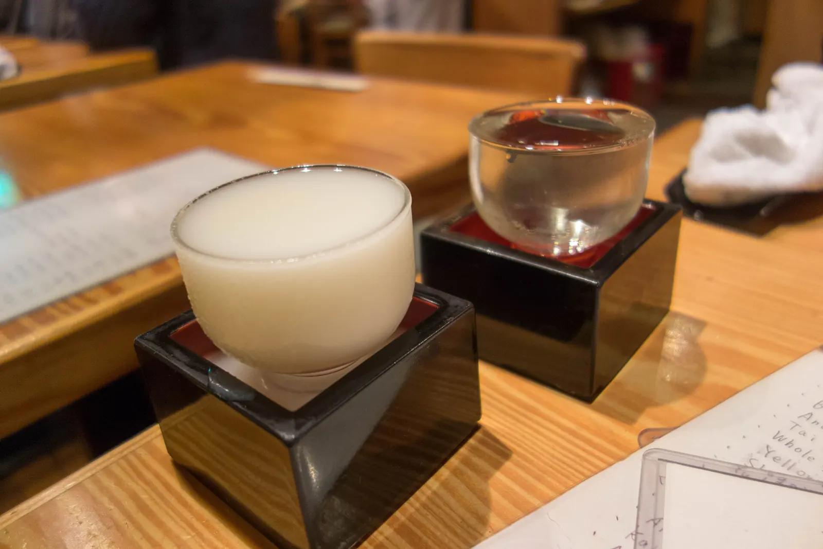 Two sakes in glasses set in masu boxes, at Sasagin