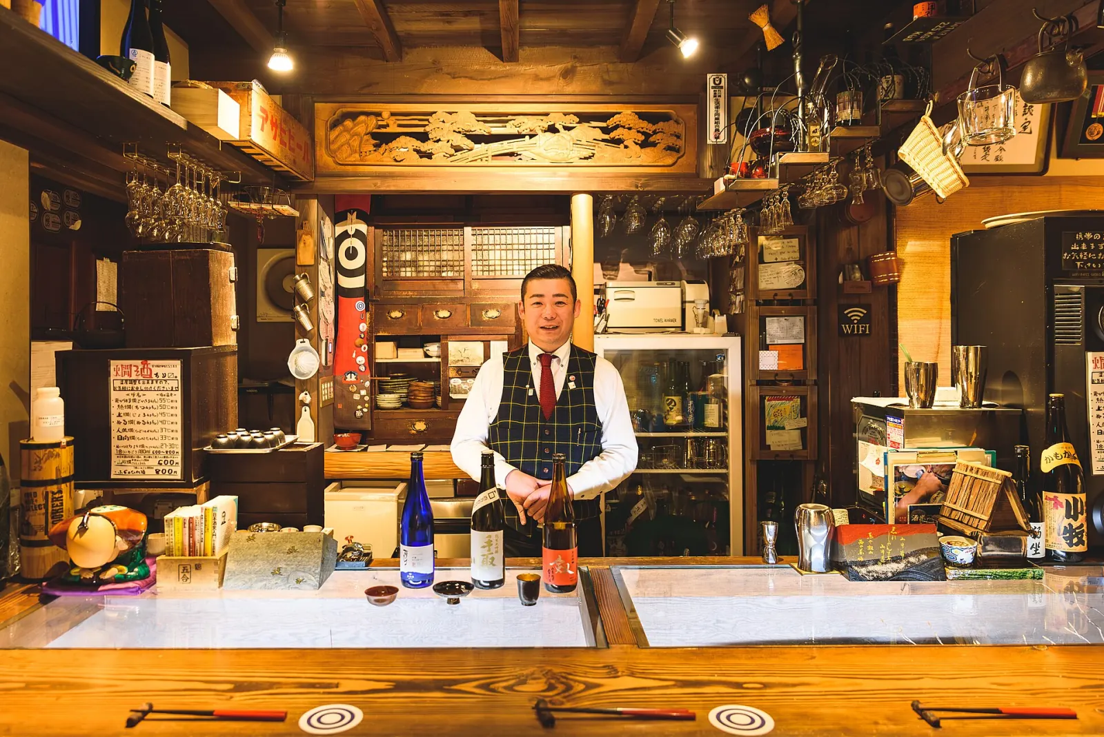 A small sake bar, bottles behind the counter