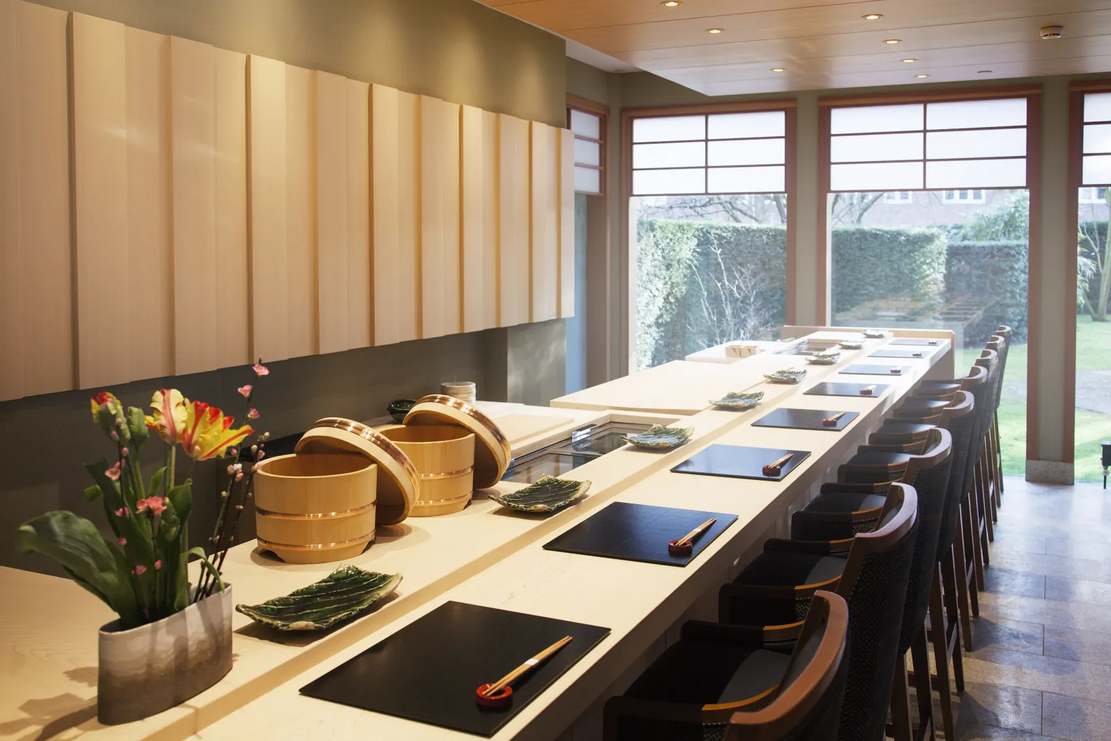 A pale wooden sushi counter