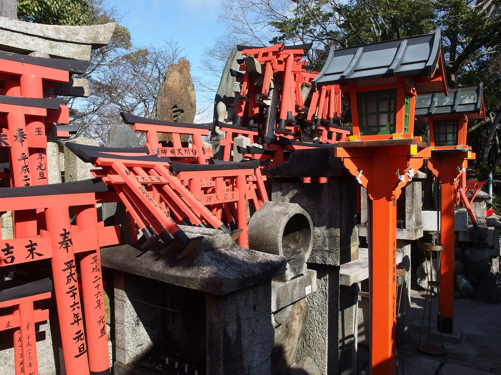 Small torii and stone shrines near the summit of Mount Inari