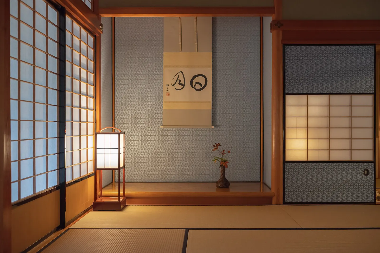 A tatami alcove with a hanging scroll, a paper lamp and a single branch