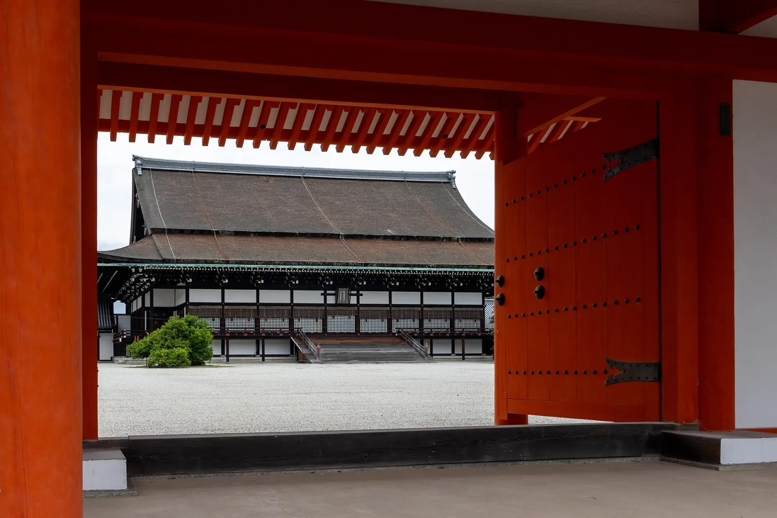 The Shishinden, framed by a vermilion gate, before its re-roofing cover
