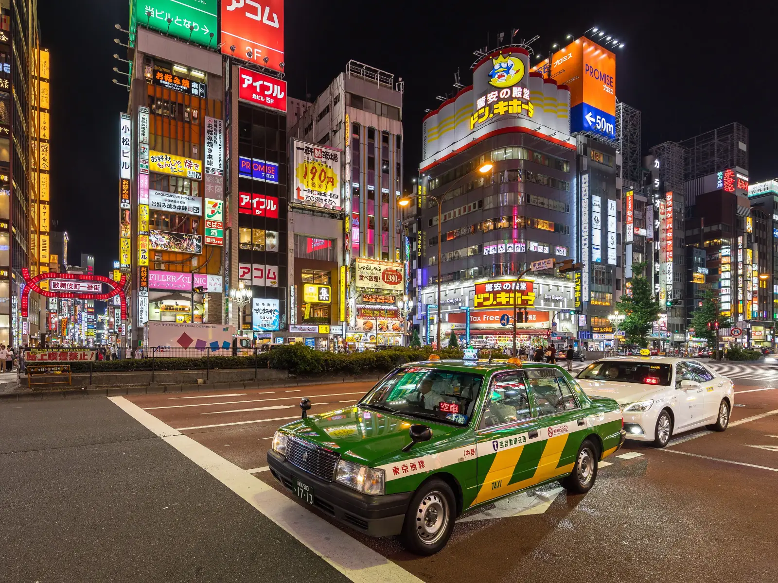 A Tokyo taxi waiting under the neon
