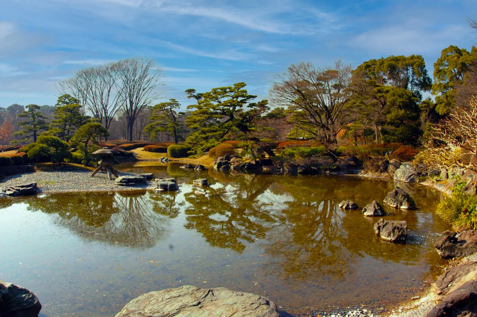 Pines and a stone lantern mirrored in the Ninomaru garden pond