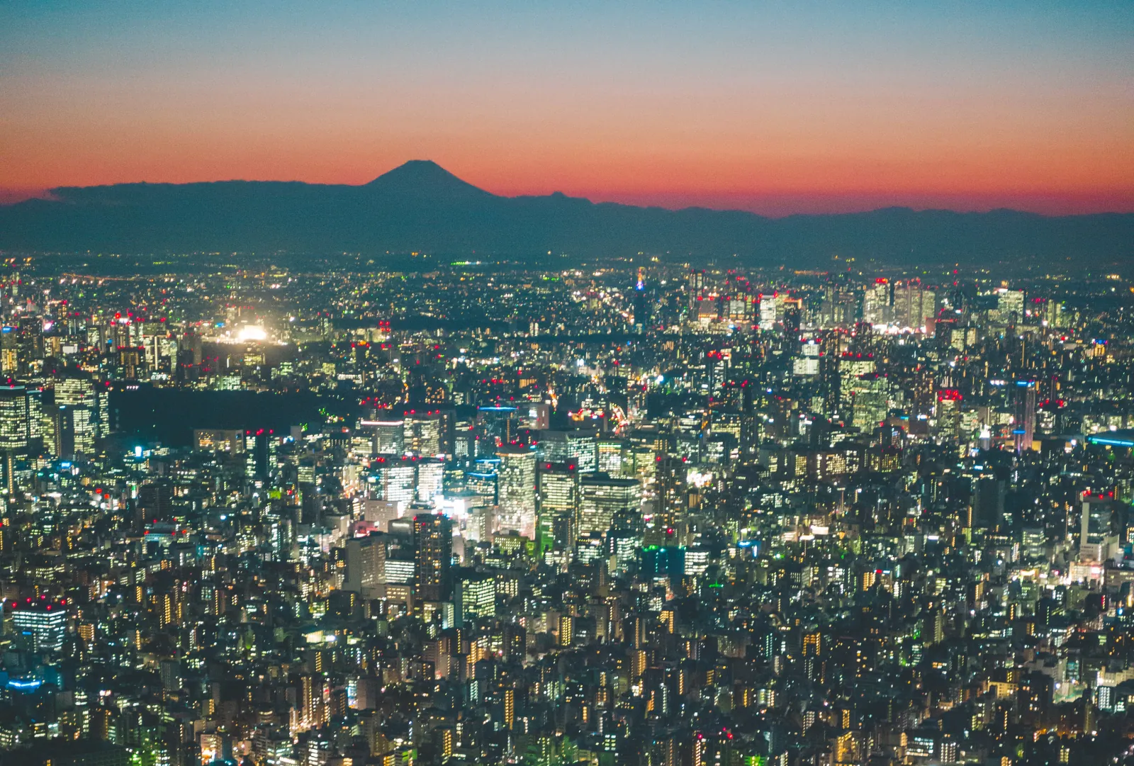 Fuji in silhouette as the sun sets behind Tokyo