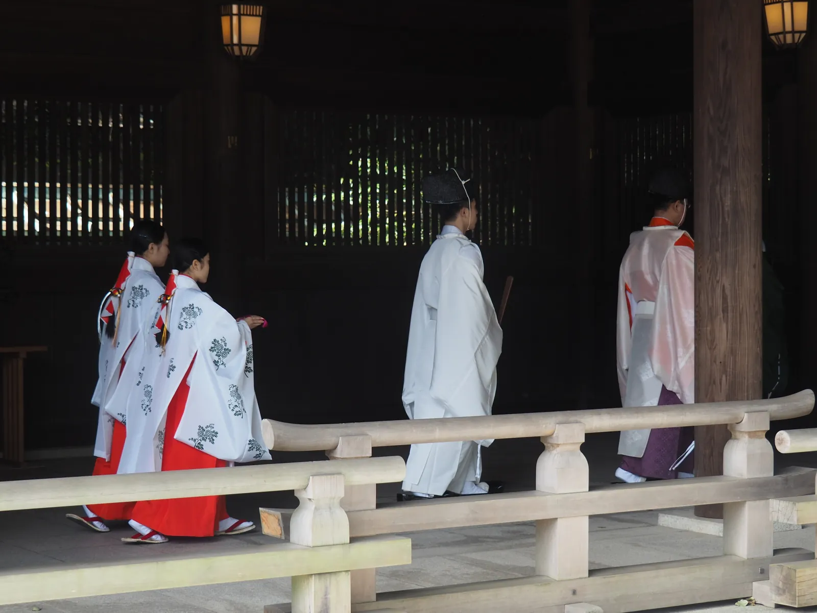 Priests and shrine maidens crossing the shrine corridor