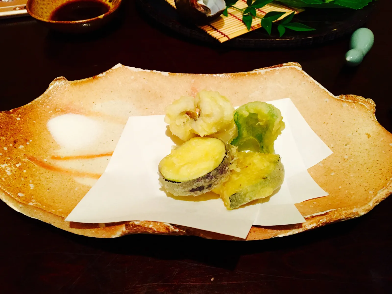 Vegetable tempura on paper, with salt for dipping