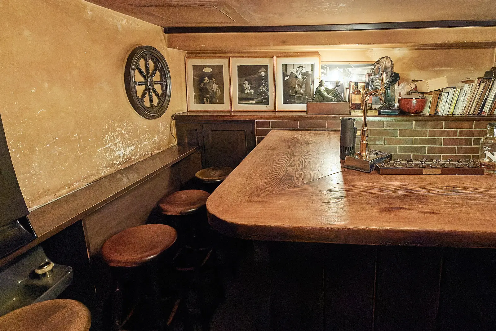 A quiet wooden bar counter, late in the evening