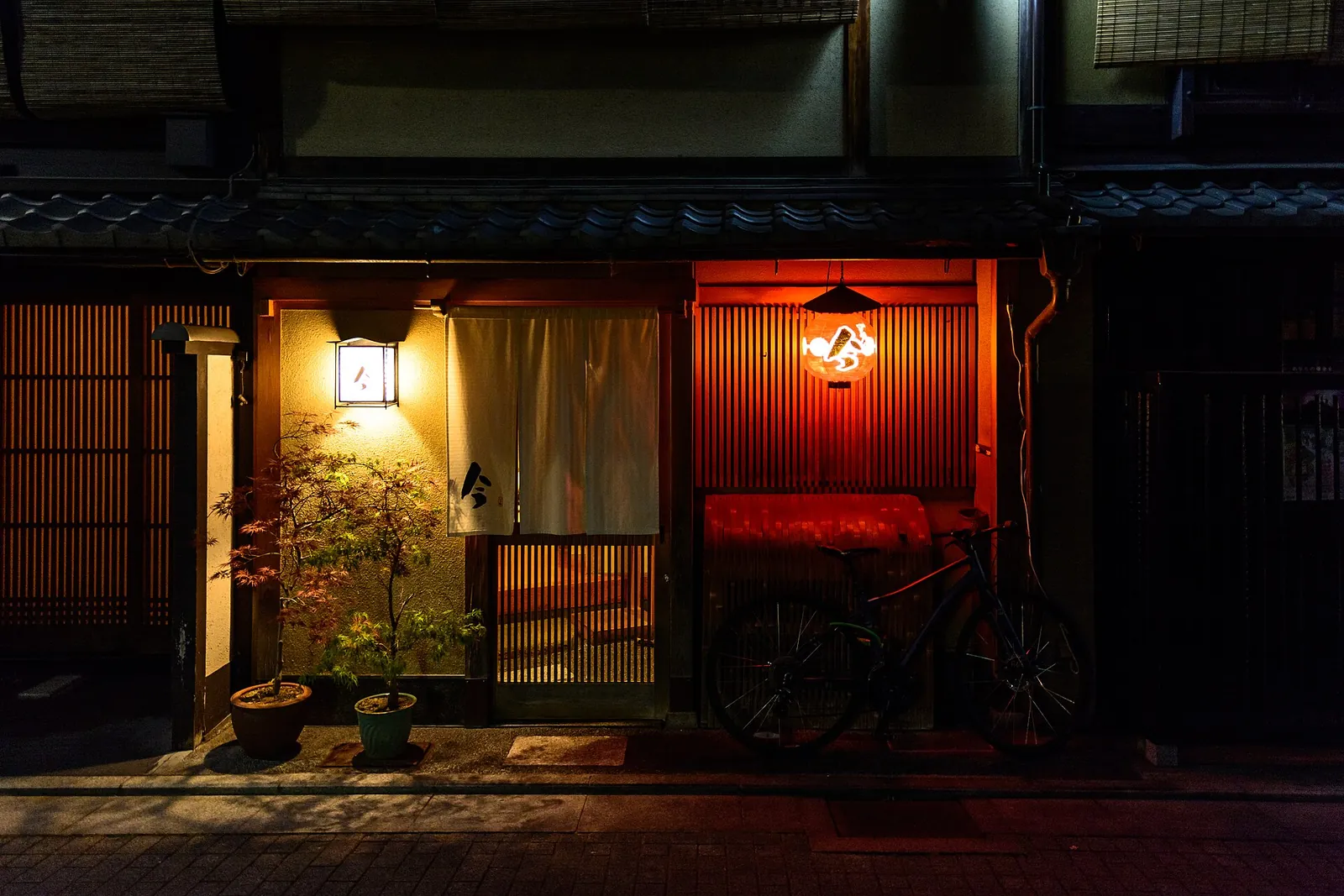 A lit doorway on a quiet Gion street
