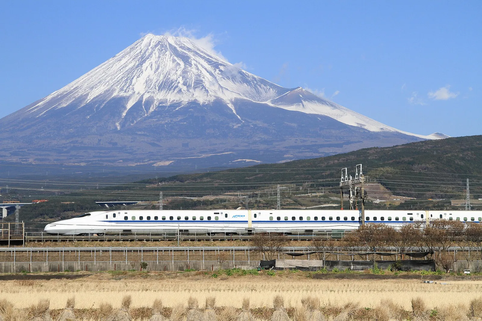 A Shinkansen below Fuji's snowy summit