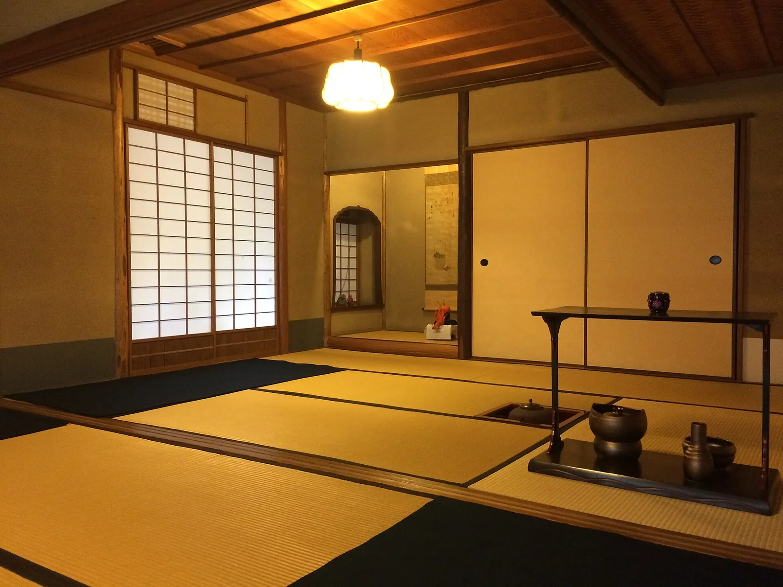 A lamp-lit tatami room, the kind kaiseki is served in